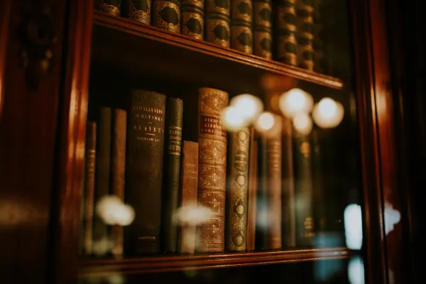 Books in a glass bookcase.